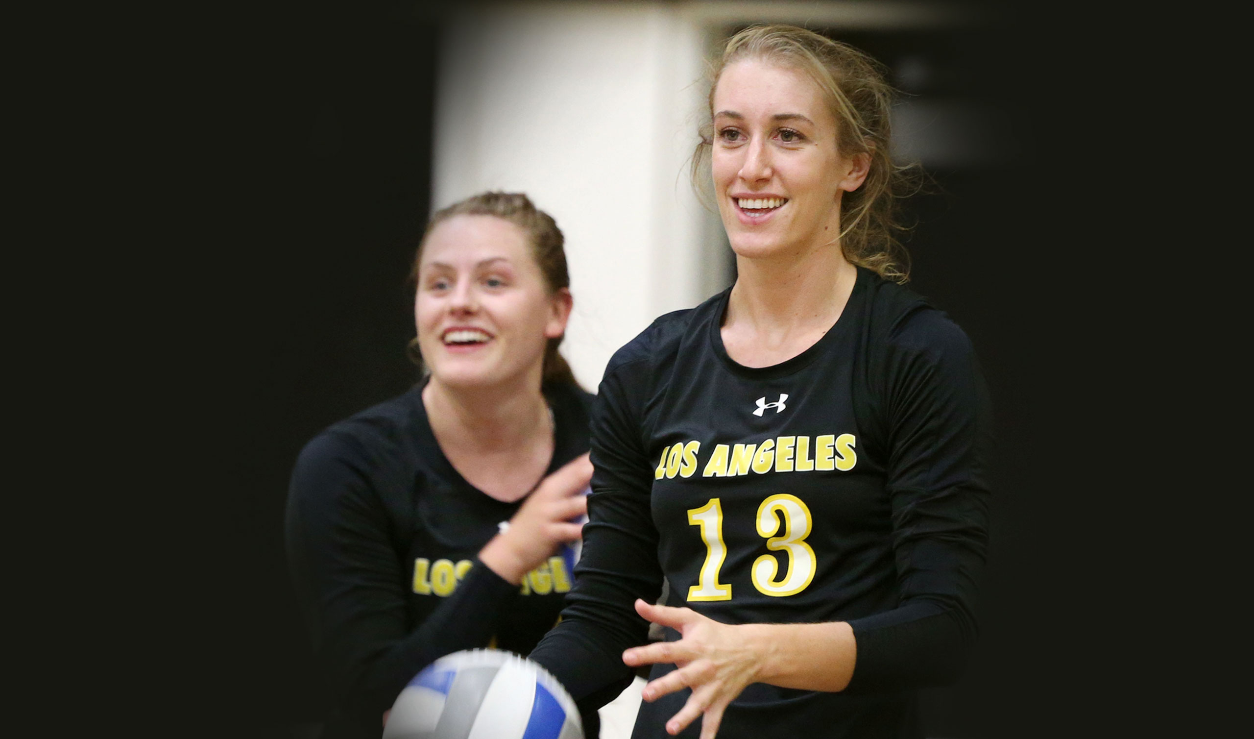 Cal State LA alumna Iona Lofrano and her volleyball teammate